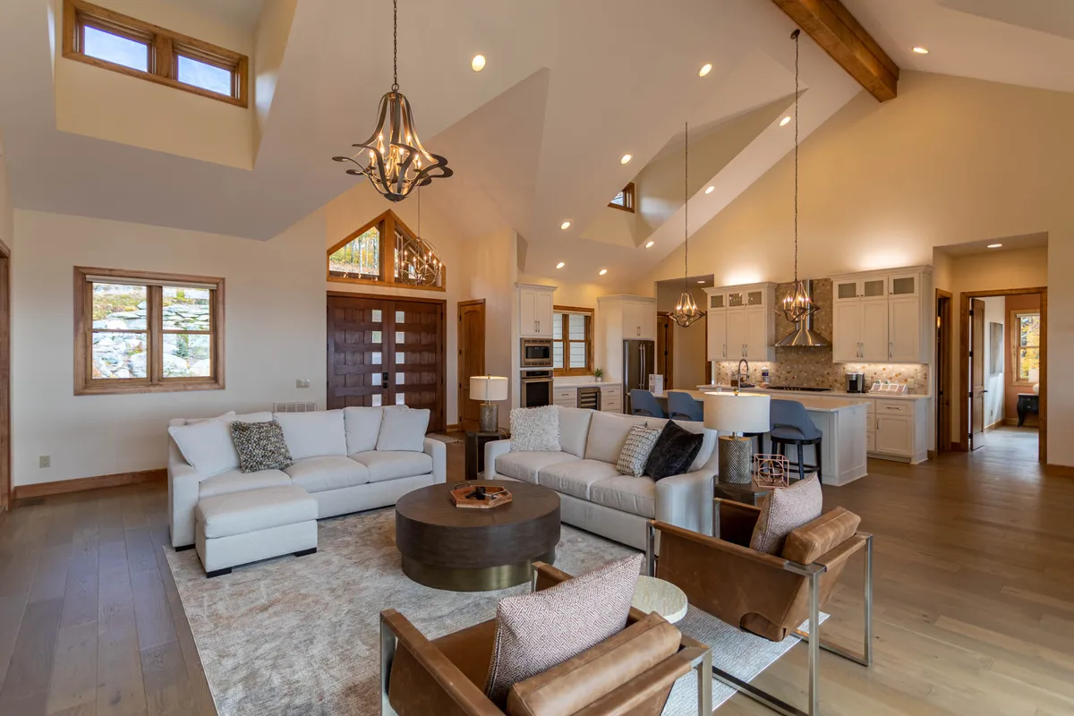 Inside, a cozy lounge with a sofa set, coffee table, and expansive windows creates an inviting environment for group activities like board games or video game tournaments. The layout encourages family interaction and leisurely fun, aligning with the section’s emphasis on shared entertainment.